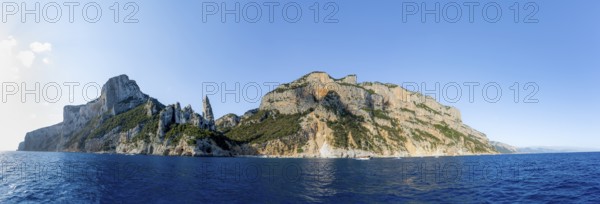 Panorama, picturesque rocky coast, cliffs with caves in the morning light, L'Aguglia rock peak,