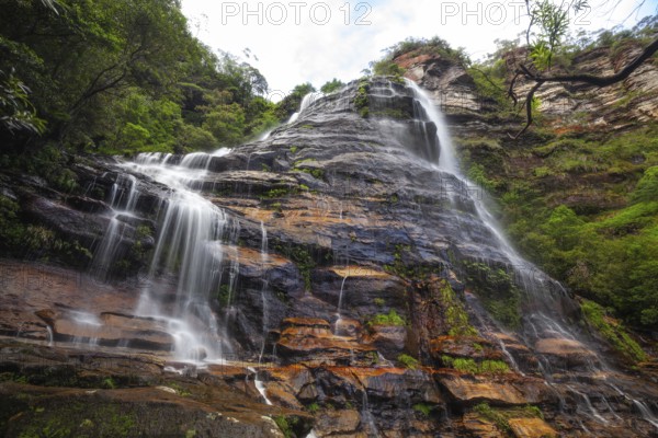 Leura Falls in a lush valley full of ferns and vegetation, Blue Mountains, New South Wales,