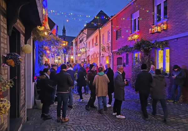 People in the Tiefstraße decorated for the Martin train in the evening, historic old town, Kempen,