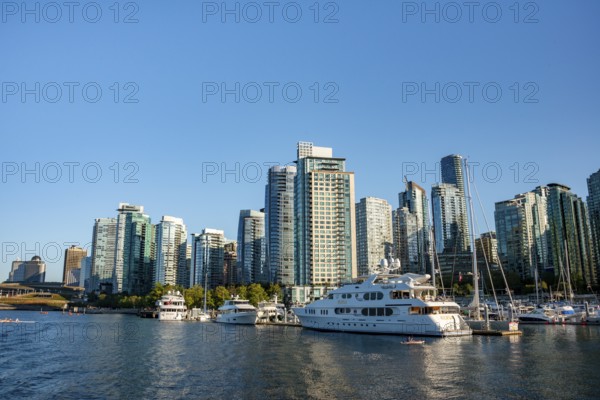 Sailing boats in marina, skyscrapers on the promenade, Coal Harbour, Vancouver, British Columbia,