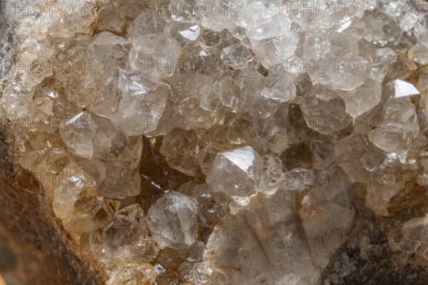 Vibrating quartz crystals mix with rock formations and capture light in a natural spring atmosphere