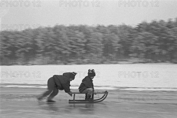 Children ride sledges on ice rink, Bleckede, Lower Saxony, Germany, January 04, 1995, vintage,