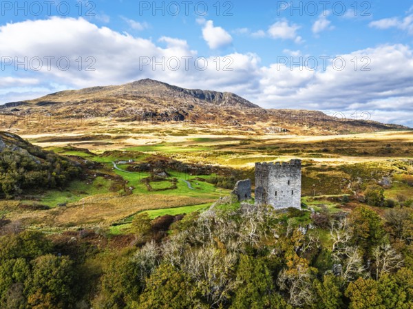Autumn colours over Castell Dolwyddelan and Eryri Mountains from a drone, Snowdonia, Conwy County