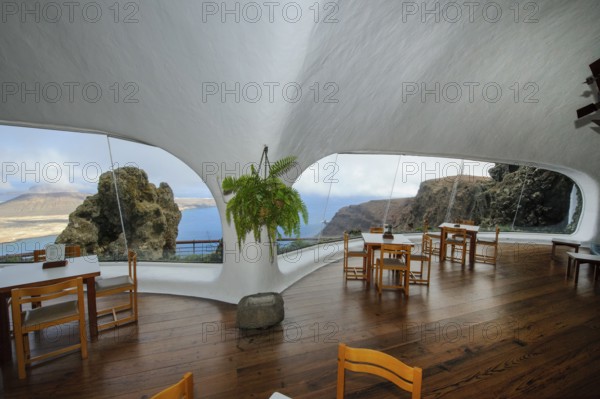 Interior of café with panoramic window in building designed by Cesar Manrique with the