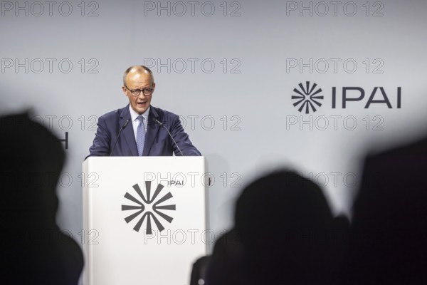 Federal Chancellor Friedrich Merz (CDU) . Portrait at the lectern with free text space.