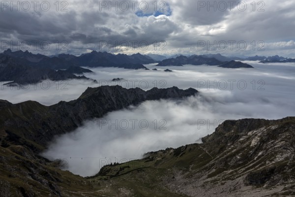 View from the Nebelhorn summit to mountains of the Allgäu Alps, mountains rising from fog in the