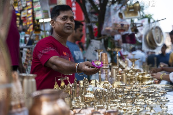 People shop for bronze and other metal items at a roadside stall on Dhanteras, in Guwahati, Assam,