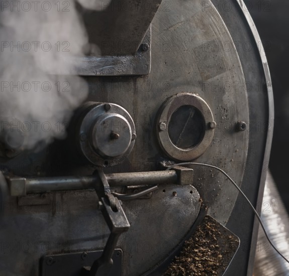Machine for roasting coffee beans called roaster with a special automatic mixing device at work in