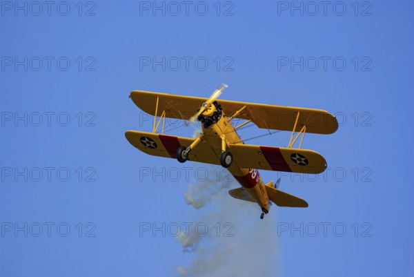 A Boeing-Stearman biplane during a flight demonstration as part of an air show at the Rossfeld in