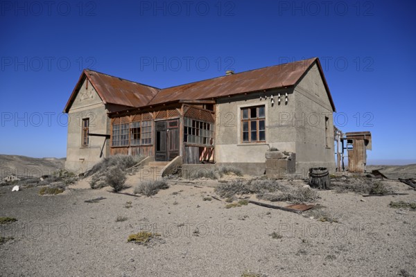 Dilapidated building in the desert sand, Pomona, restricted diamond area, near Lüderitz, Karas