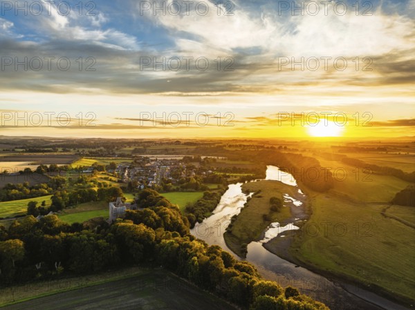 Sunset over Norham Castle and River Tweed from a drone, Norham, Northumberland, England, United