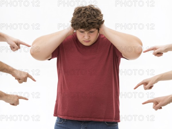 Overweight boy being judged by pointing fingers, symbolising fatshaming, bullying, judgement and
