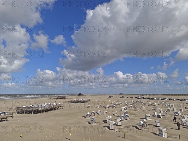 North Sea beach with sand drifts, car park, blue sky, white clouds, summer, sun, beach chairs, on