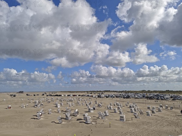 North Sea beach, car park, blue sky, white clouds, summer, sun, sand, beach chairs, on the edge of