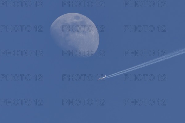Boeing 737 jet passenger aircraft of Norweign Air with a vapour trial or contrail behind flying in