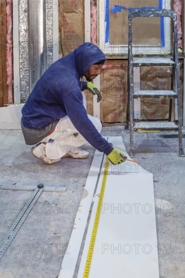 Detroit, Michigan - Workers remodel a house in the Morningside neighborhood that had been vacant