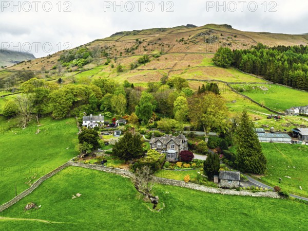 Farms and Mountains over road A591 from a drone, Grasmere Lake, Grasmere, Ambleside, Lake District,