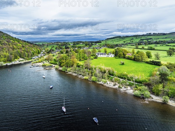 Farms and mountains over Ullswater Lake from drone, Pooley Bridge, Lake District National Park,