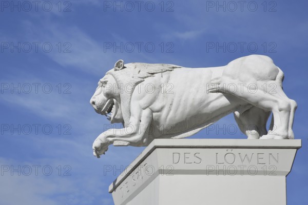 White Lion Monument by Peter Lenk 1996 with inscription Die Spur des Löwen and monument to the city