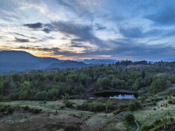 Sunset over Mountains and Coniston Water from drone, Lake District National Park, Cumbria, England,