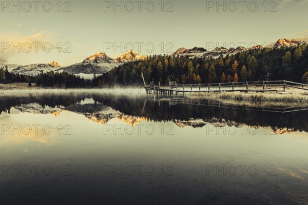 Lake Staz near Sankt Moritz in the Engadin in Switzerland. Morning atmosphere with fog in autumn.