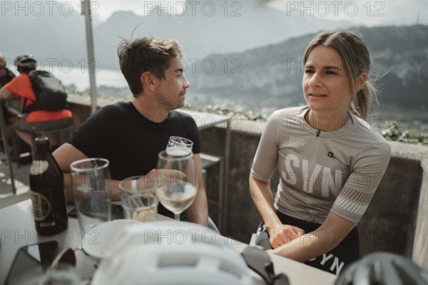 Young man taking a coffee break while riding his racing bike on Lake Garda. Sunny weather and dolce