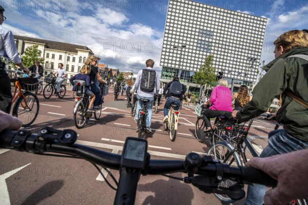 Ride your bike on the central cycle path on Lange Viestraat, Vredenburg, in the city centre of