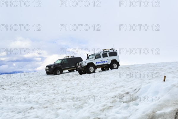 Two super jeeps parked next to each other in deep snow, glacier tour, Langjökull glacier, Husafell,
