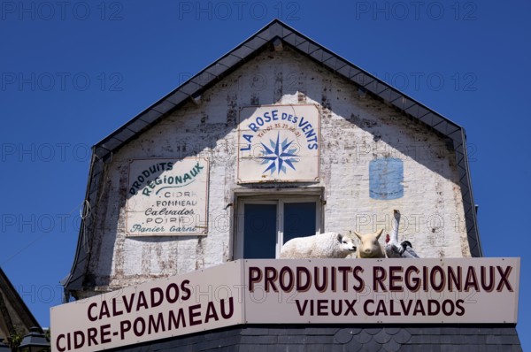 Advertising sign La Rose des Vents. Retail trade, supplier of regional products such as Calvados,