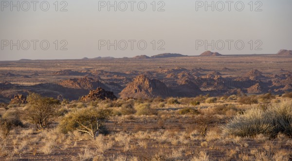 Desert landscape in the evening light at sunset, barren landscape with hills of stacked rocks,