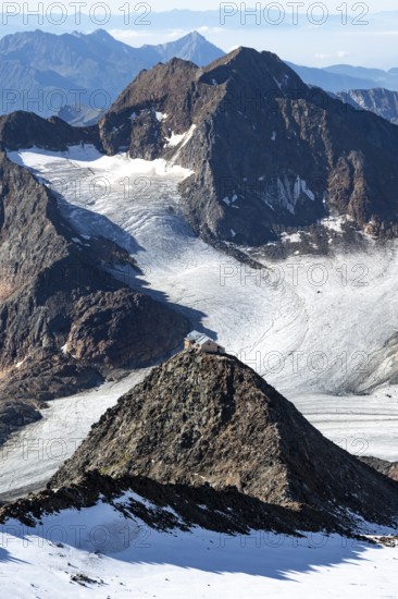 At the Wilder Freiger summit, picturesque high mountain landscape with snow, view of the