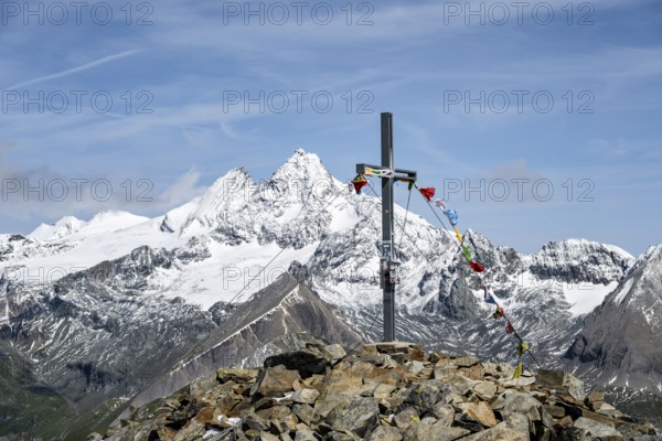 Summit cross of the summit Böses Weibl, behind summit of the Großglockner with snow, Schober group,