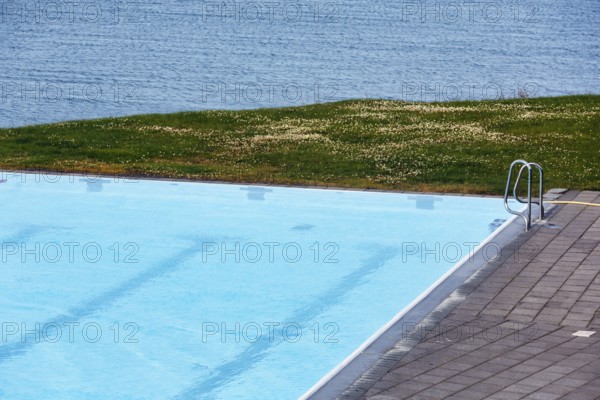 View from above of swimming pool by the sea, thermal bath, heated outdoor pool in Hofsos at the
