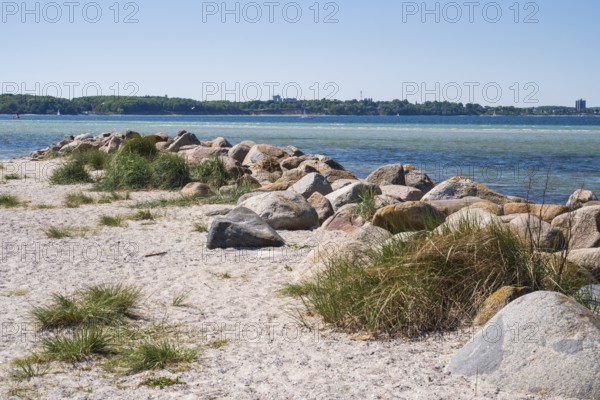 Large stones as a boundary on the sandy beach, Laboe, Baltic resort, Fjord, Baltic Sea, North