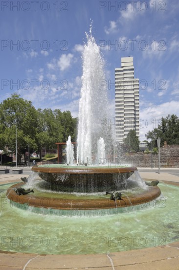 Round torch fountain by Friedrich Korter 1939 and town hall, water fountain with water basin, water