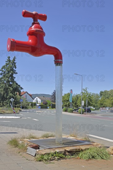 Red free-standing tap with water jet, fountain, modern art, sculpture, dummy, figure, pipeline,