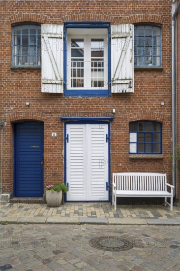 Window with shutters, brick façade, warehouse building, old town centre, Husum, North Frisia,