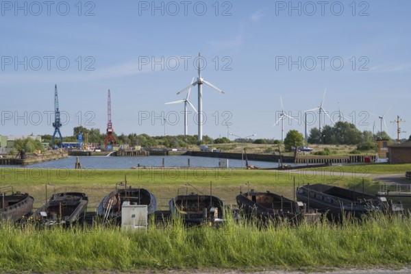 Old barges, shipyard, wind turbines, Dockkoog, Husum, North Frisia, Schleswig-Holstein, Germany