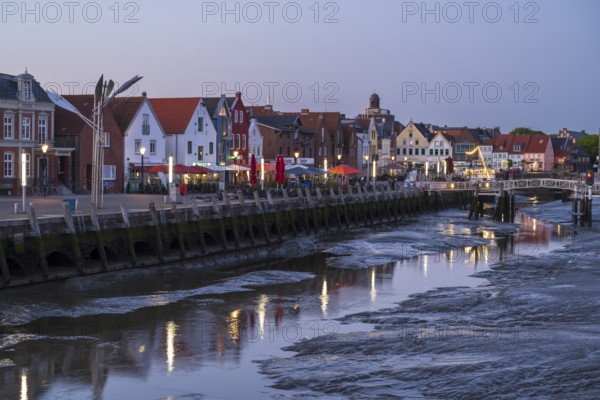 Buildings at the harbour, skyline, low tide, illuminated, blue hour, Husum, North Sea, North