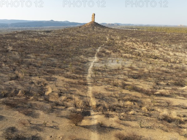 The Vingerklip (rock finger) is surrounded by thornbush and mopane (Colophospermum mopane) savanna.