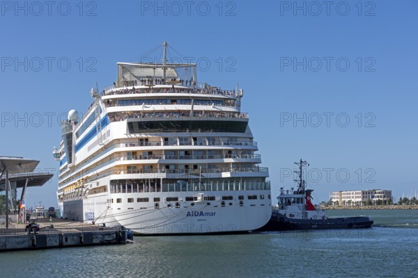 Cruise ship AIDA nova is pushed against the quay wall by tugboats, Warnow, Warnemünde, Rostock,
