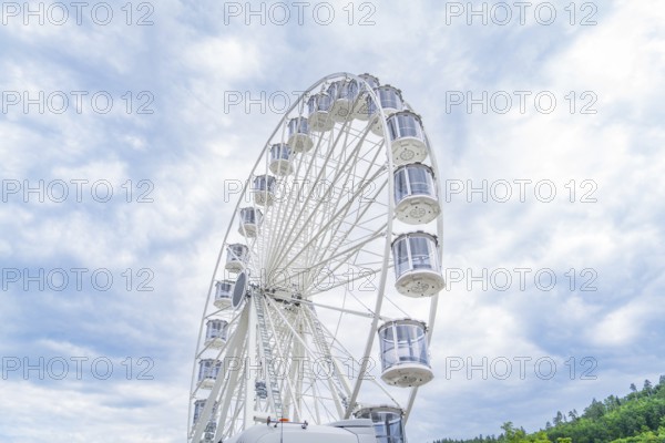 Ferris wheel in full height in front of a cloudy sky, Ferris wheel construction for the 950th