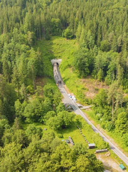 A wooded area with a railway line and a tunnel in the middle, construction of the Hermann Hesse