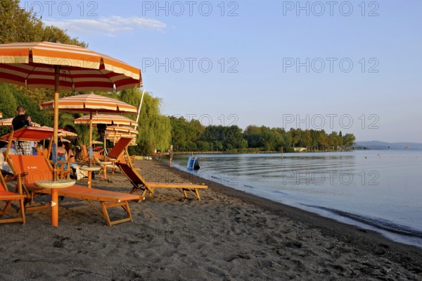 Beach, deckchairs, sunshades at the lido, Lake Bolsena, Lago di Bolsena, volcanic crater lake, calm