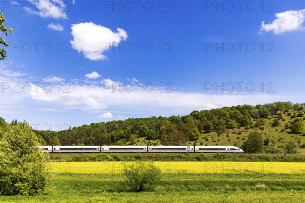 InterCityExpress ICE en route on the Swabian Alb near Lonsee. Landscape on the railway's