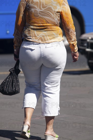 Woman walking in the street, From behind, Obesity, City of Quito. Pichincha province, Ecuador,