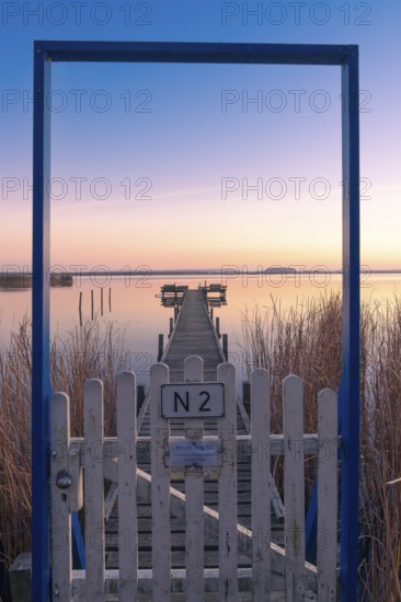 View along a footbridge through a door frame to the Steinhuder Meer in the evening light, Great