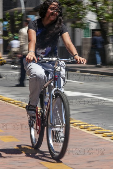 Woman riding a bicycle, Photo with motion blur, City of Quito, Pichincha province, Ecuador, South