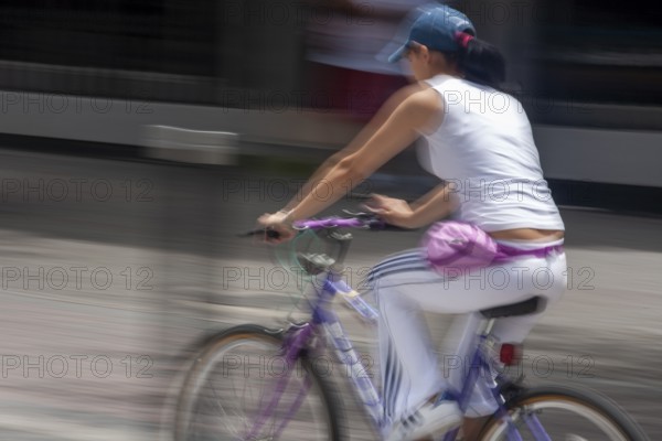 Woman riding a bicycle, Photo with motion blur, City of Quito, Pichincha province, Ecuador, South