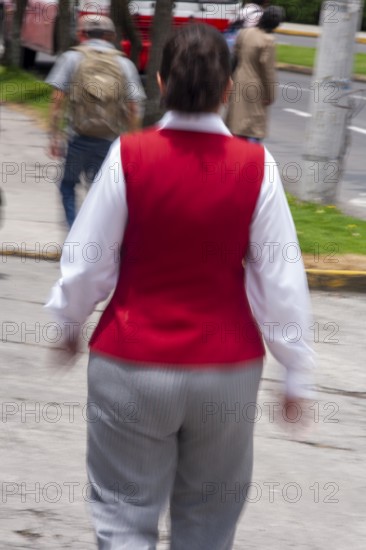 Woman walking in street, Photo with motion blur, City of Quito, Pichincha province, Ecuador, South